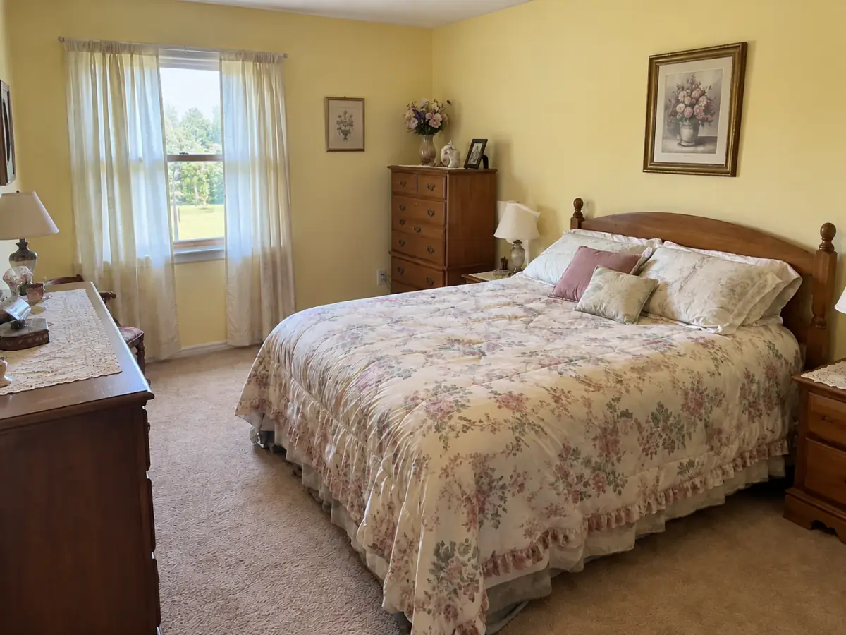 dated bedroom with floral comforter and yellow walls, before AI redesign